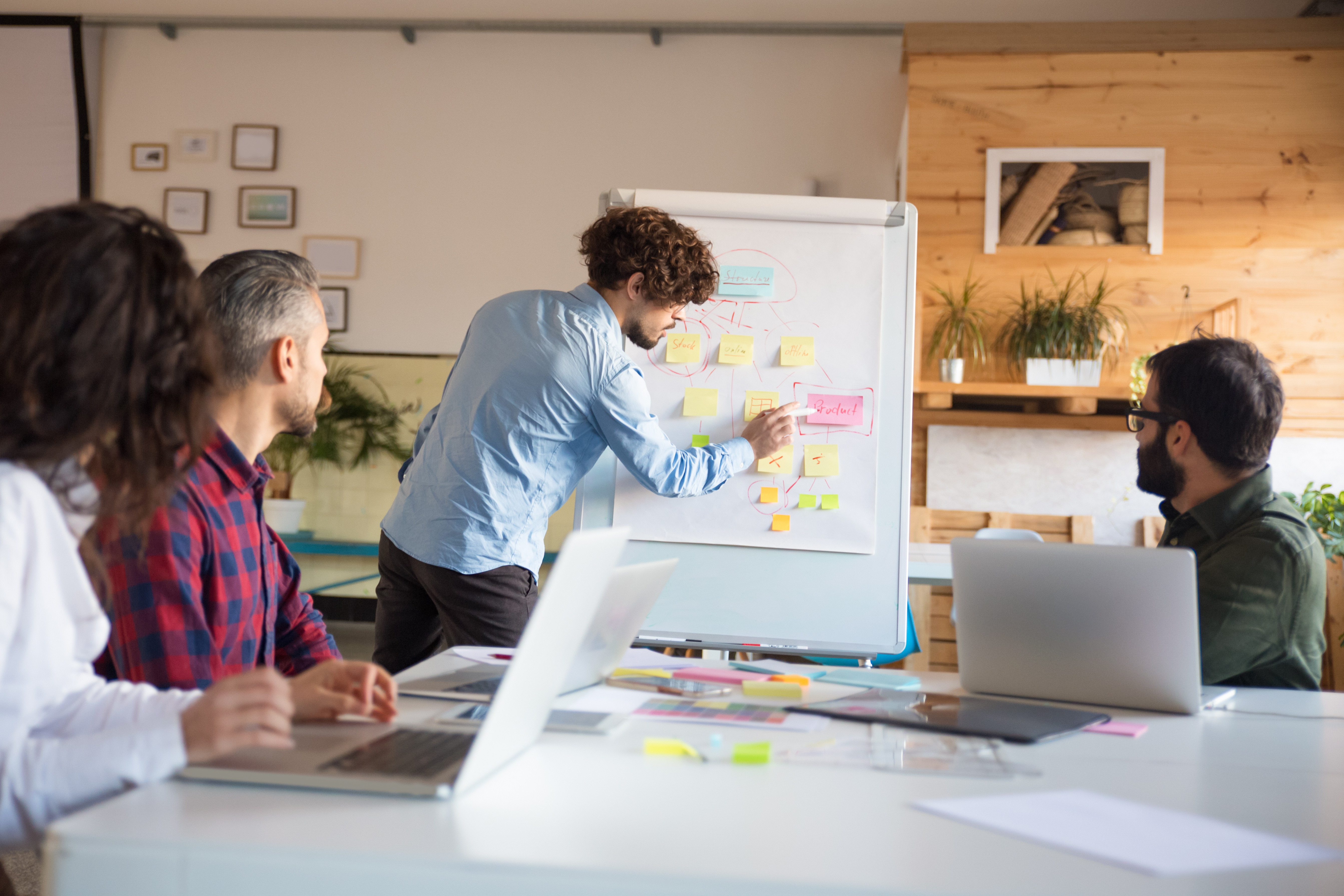 Business colleagues in casual working together in contemporary office space. 